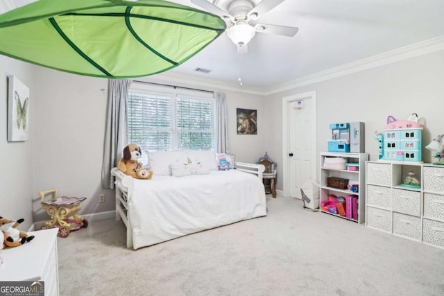 carpeted bedroom featuring ornamental molding, baseboards, and ceiling fan