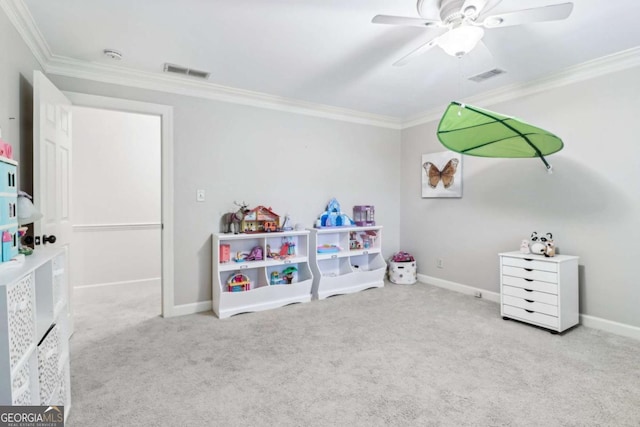 game room featuring ornamental molding, carpet floors, a ceiling fan, and baseboards