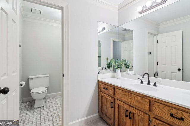 bathroom with toilet, vanity, ornamental molding, and baseboards