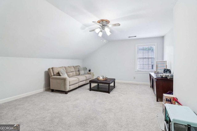 living room featuring a ceiling fan, baseboards, lofted ceiling, and carpet flooring