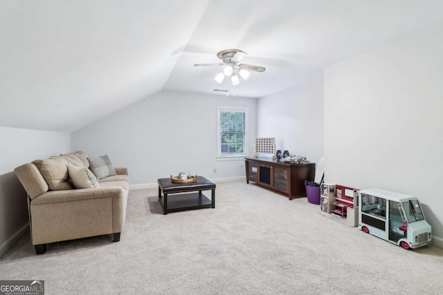 living area featuring a ceiling fan, carpet floors, vaulted ceiling, and baseboards