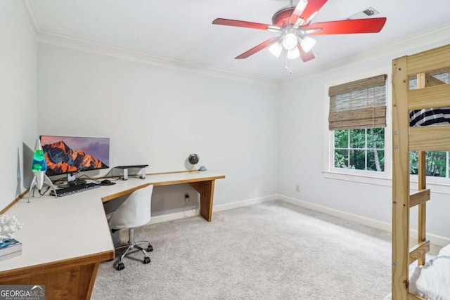 carpeted home office with ornamental molding, a ceiling fan, and baseboards