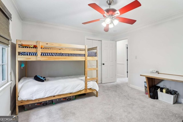 bedroom featuring crown molding, carpet, baseboards, and a ceiling fan