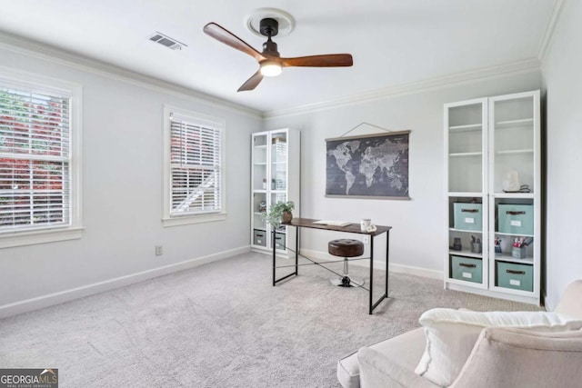 carpeted office with a ceiling fan, crown molding, baseboards, and plenty of natural light