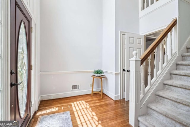 entryway featuring stairway, light wood-style flooring, and baseboards