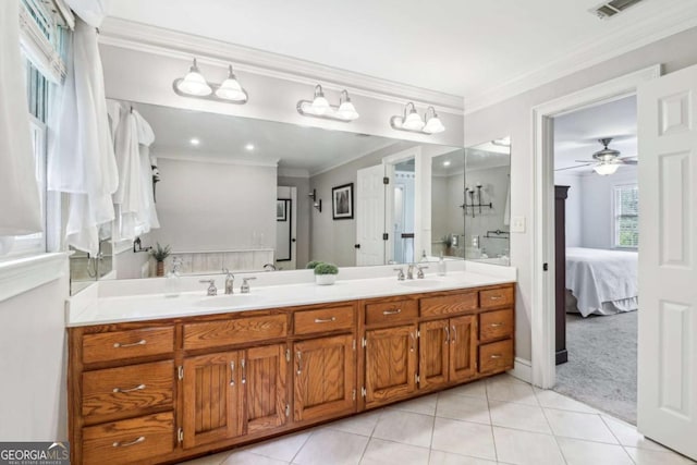 bathroom with tile patterned flooring, crown molding, double vanity, a ceiling fan, and ensuite bathroom