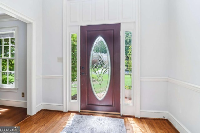 entryway with wood finished floors and plenty of natural light