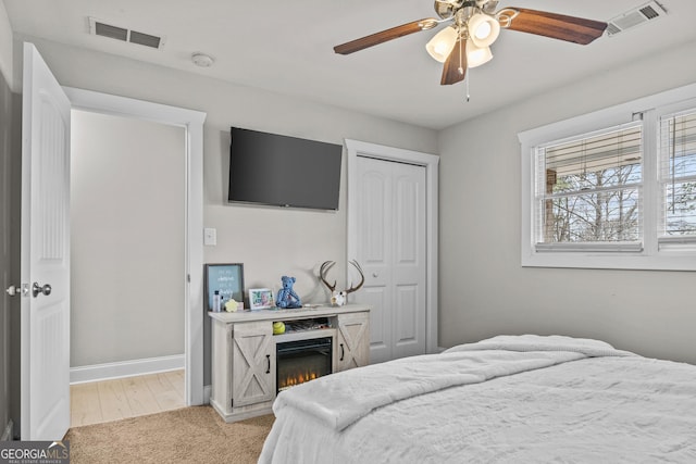 4739 Lower Jersey Rd, Oxford, GA 30054 - bedroom with baseboards, a closet, light carpet, and ceiling fan