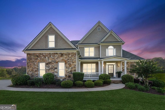 79 Gold Creek Ct, Dawsonville, GA 30534 - view of front of house with a porch, a lawn, and stone siding