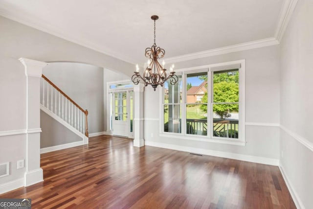 79 Gold Creek Ct, Dawsonville, GA 30534 - unfurnished dining area with arched walkways, a chandelier, stairs, wood finished floors, and crown molding