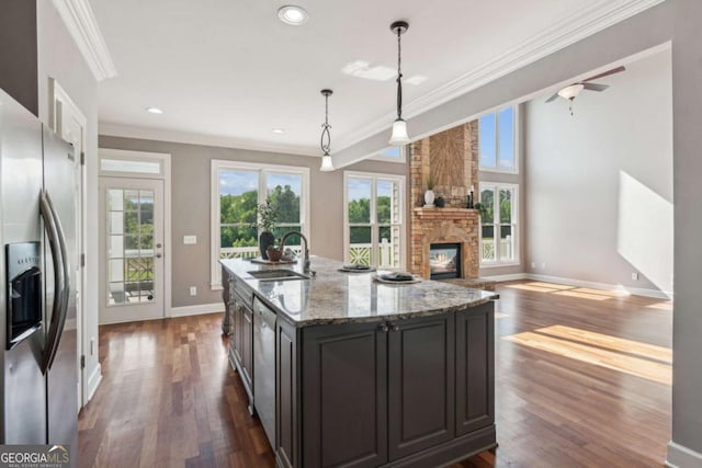 79 Gold Creek Ct, Dawsonville, GA 30534 - kitchen featuring appliances with stainless steel finishes, a sink, crown molding, a fireplace, and dark wood-style flooring