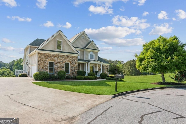 79 Gold Creek Ct, Dawsonville, GA 30534 - view of front of property featuring stone siding, concrete driveway, a front lawn, and an attached garage