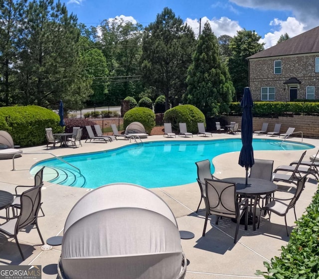 805 Pleasant Hill Rd NW Unit 343, Lilburn, GA 30047 - community pool featuring fence, a patio, and view of wooded area