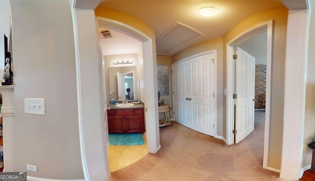 805 Pleasant Hill Rd NW Unit 343, Lilburn, GA 30047 - hallway with light colored carpet, a sink, arched walkways, and baseboards