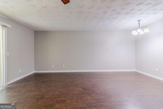 5509 Covent Way, Lithonia, GA 30058 - unfurnished room featuring dark wood-style floors, a chandelier, a textured ceiling, and a ceiling fan