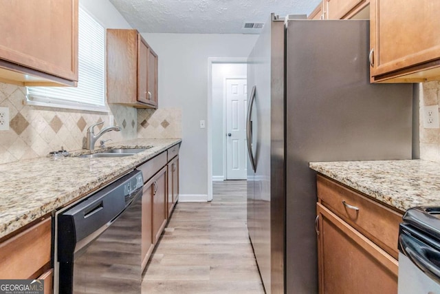 5509 Covent Way, Lithonia, GA 30058 - kitchen with dishwasher, light wood-style floors, tasteful backsplash, and a textured ceiling