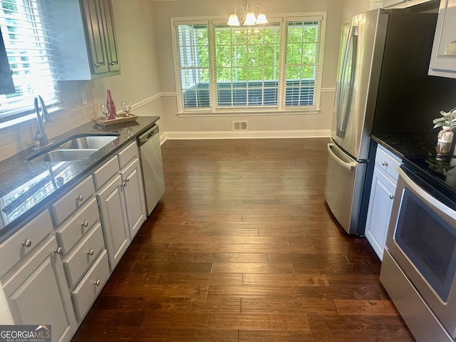 4790 Brandon Acres Ln, Buford, GA 30519 - kitchen featuring stainless steel appliances, a sink, dark wood-type flooring, baseboards, and a chandelier
