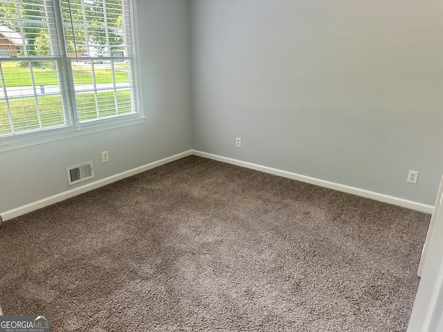 4790 Brandon Acres Ln, Buford, GA 30519 - spare room featuring baseboards and dark colored carpet