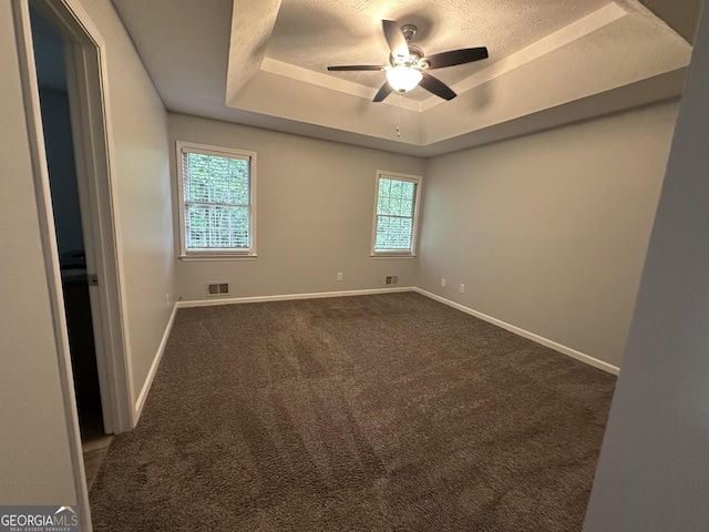 4790 Brandon Acres Ln, Buford, GA 30519 - unfurnished room with a raised ceiling, baseboards, a ceiling fan, dark colored carpet, and a textured ceiling
