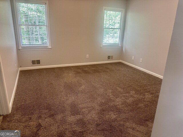 4790 Brandon Acres Ln, Buford, GA 30519 - spare room with dark colored carpet and baseboards