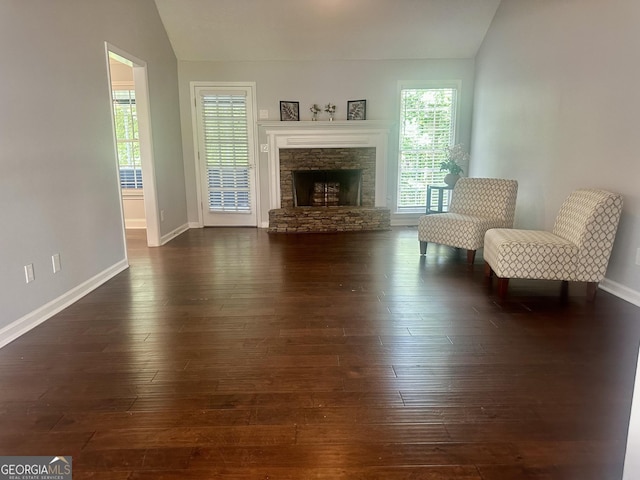4790 Brandon Acres Ln, Buford, GA 30519 - living area featuring vaulted ceiling, baseboards, dark wood-style flooring, and a stone fireplace