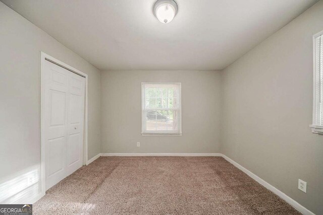 3731 Adkins Rd NW, Atlanta, GA 30331 - unfurnished bedroom featuring carpet floors, baseboards, and multiple closets