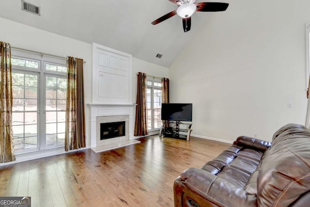 1095 S Bethany Creek Dr, Alpharetta, GA 30004 - living area featuring ceiling fan, light wood-style flooring, a fireplace, high vaulted ceiling, and baseboards