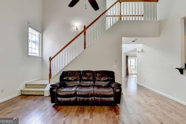 1095 S Bethany Creek Dr, Alpharetta, GA 30004 - living area featuring wood-type flooring, ceiling fan, stairs, a towering ceiling, and baseboards