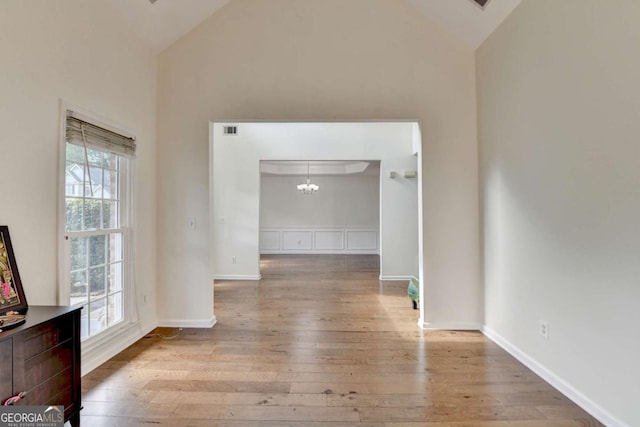 1095 S Bethany Creek Dr, Alpharetta, GA 30004 - hall with wood-type flooring, high vaulted ceiling, a chandelier, and baseboards