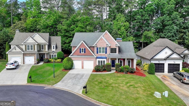 1095 S Bethany Creek Dr, Alpharetta, GA 30004 - view of front of property with driveway, a chimney, a front lawn, and view of wooded area