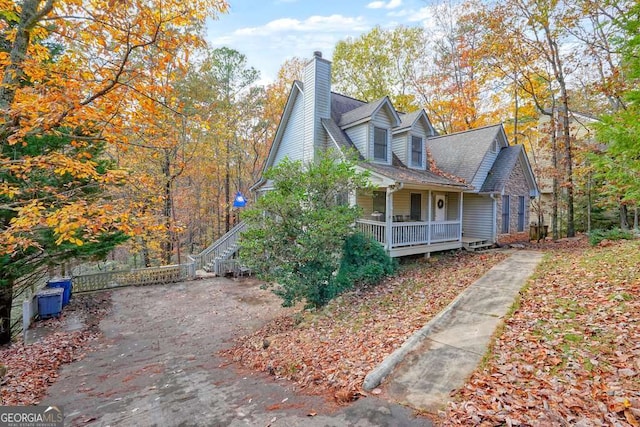 view of home's exterior featuring a porch and a chimney