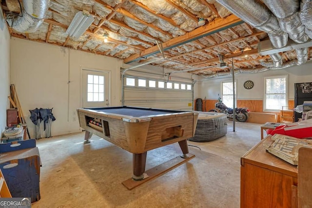 game room featuring concrete flooring, a garage, billiards table, healthy amount of natural light, and wainscoting