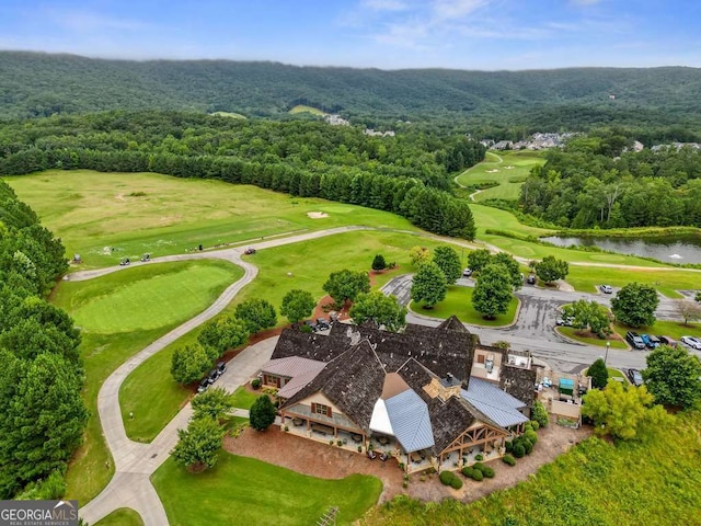 bird's eye view of a nearby body of water, a forest, and a local golf course