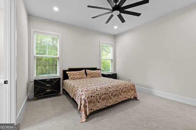 carpeted bedroom with multiple windows, baseboards, recessed lighting, and ceiling fan