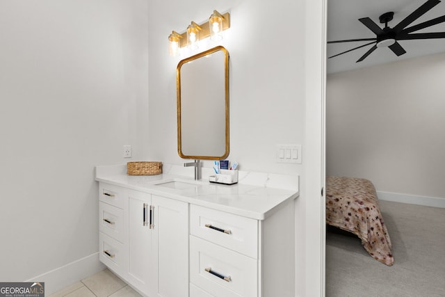 bathroom with a ceiling fan, baseboards, and vanity