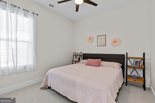 carpeted bedroom featuring baseboards and a ceiling fan