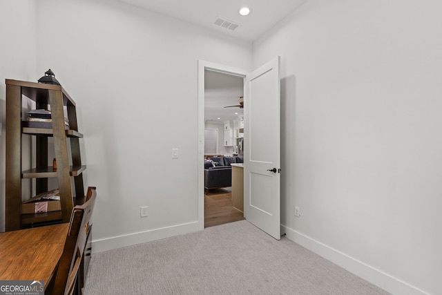 carpeted home office featuring ceiling fan and baseboards