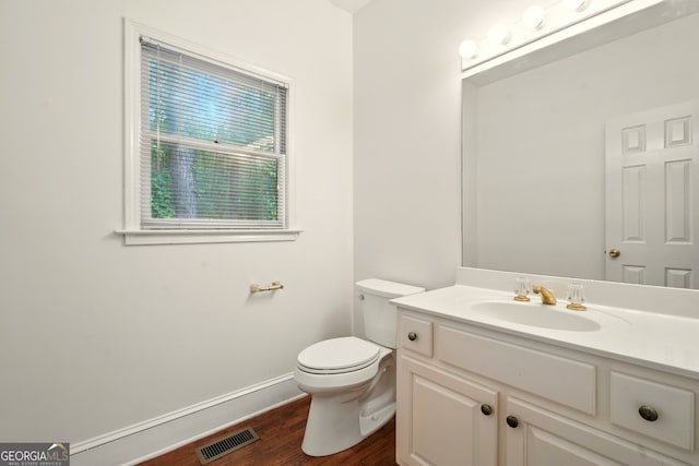 1256 Spring Park Dr SW, Atlanta, GA 30311 - bathroom featuring wood finished floors, toilet, vanity, and baseboards