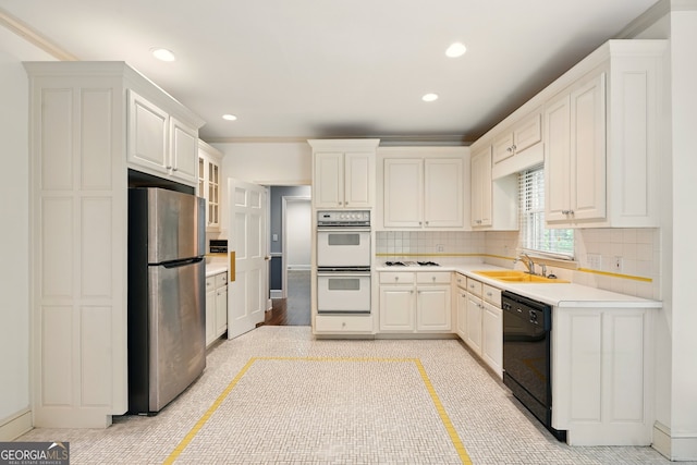 1256 Spring Park Dr SW, Atlanta, GA 30311 - kitchen with freestanding refrigerator, black dishwasher, double oven, a sink, and light countertops