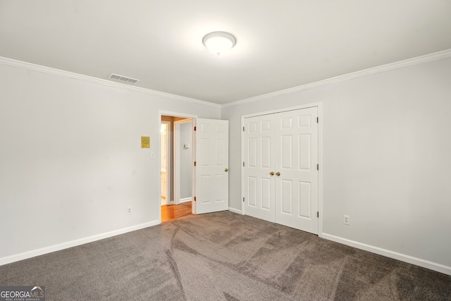1256 Spring Park Dr SW, Atlanta, GA 30311 - unfurnished bedroom featuring carpet floors, crown molding, baseboards, and a closet
