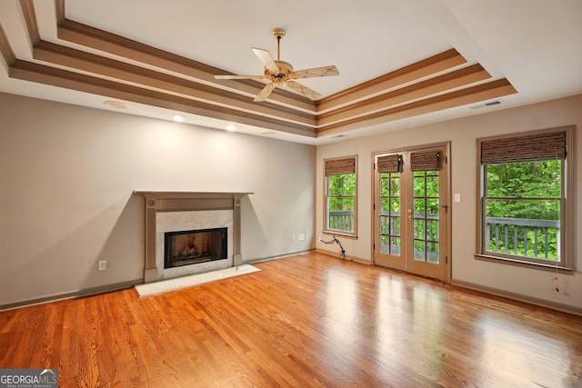 1256 Spring Park Dr SW, Atlanta, GA 30311 - unfurnished living room with a tray ceiling, a fireplace, healthy amount of natural light, and a ceiling fan