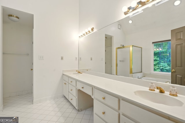 1256 Spring Park Dr SW, Atlanta, GA 30311 - full bathroom with a shower stall, tile patterned flooring, double vanity, a garden tub, and baseboards