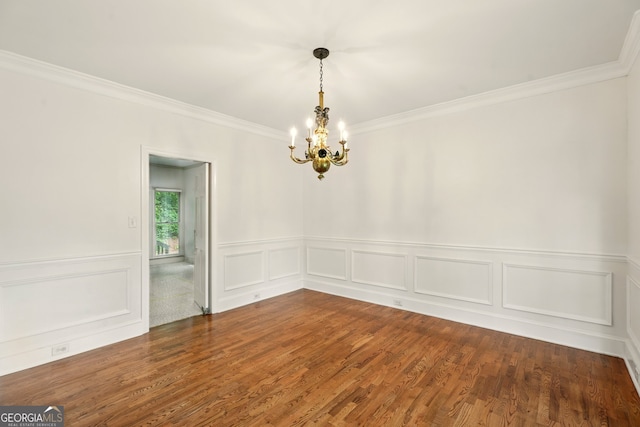 1256 Spring Park Dr SW, Atlanta, GA 30311 - empty room featuring a chandelier, crown molding, wood finished floors, a wainscoted wall, and a decorative wall