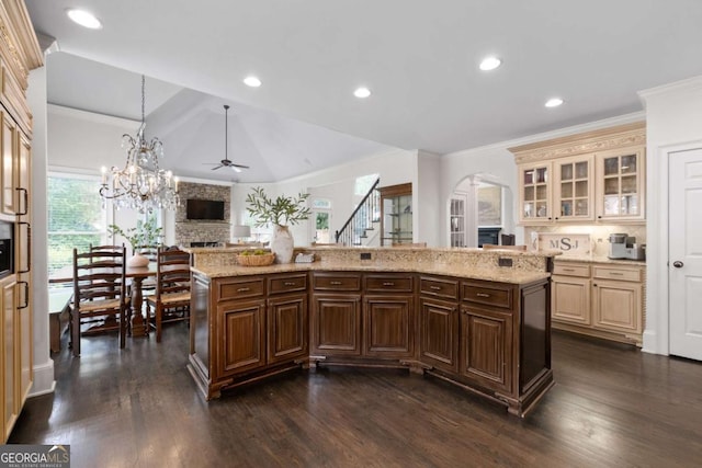 kitchen with open floor plan, ceiling fan, dark wood finished floors, glass insert cabinets, and lofted ceiling