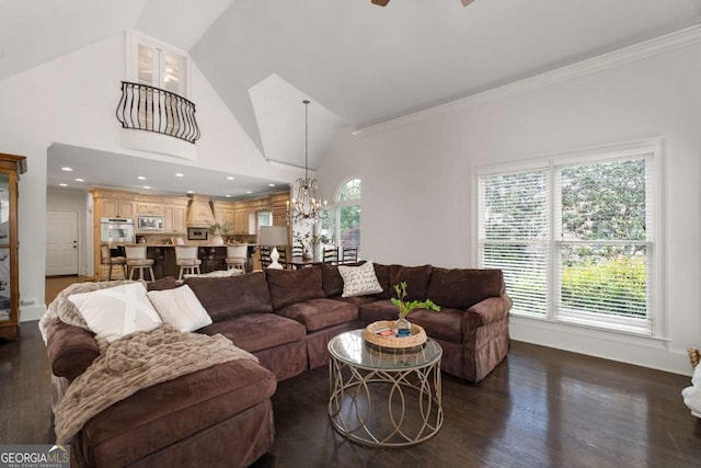 living area with a chandelier, dark wood-style floors, crown molding, a ceiling fan, and high vaulted ceiling