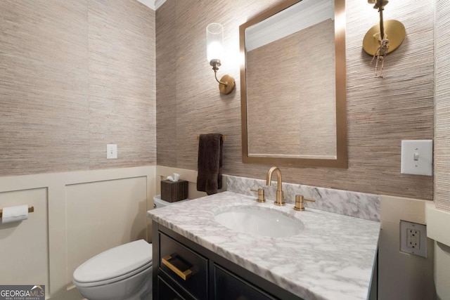 half bathroom featuring toilet and vanity