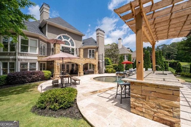 view of patio featuring a balcony and a pergola