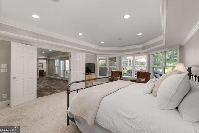 bedroom featuring a raised ceiling, ornamental molding, recessed lighting, french doors, and baseboards