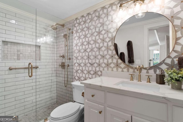 bathroom featuring ornamental molding, a stall shower, toilet, and vanity