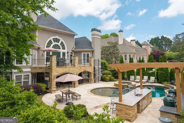 view of swimming pool with stairs, a patio, and a pool with connected hot tub